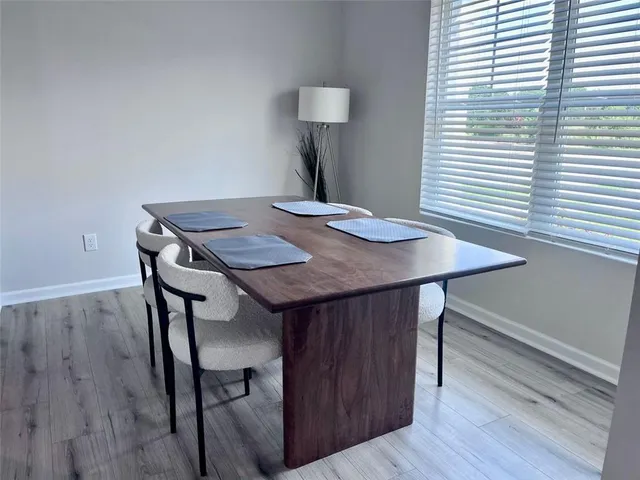 a view of a dining room with furniture and wooden floor