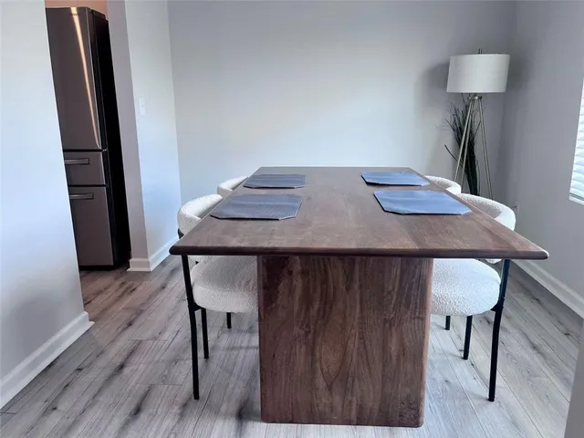 a view of a room with furniture and wooden floor