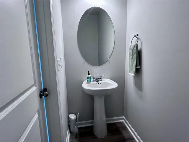 a bathroom with a sink toilet and a mirror