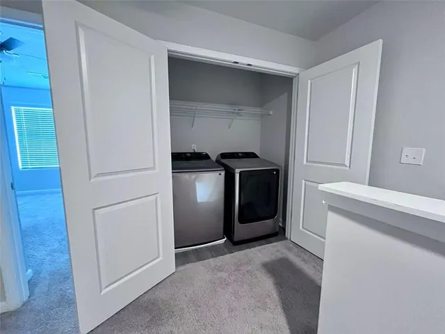 a view of storage and utility room with washer and dryer