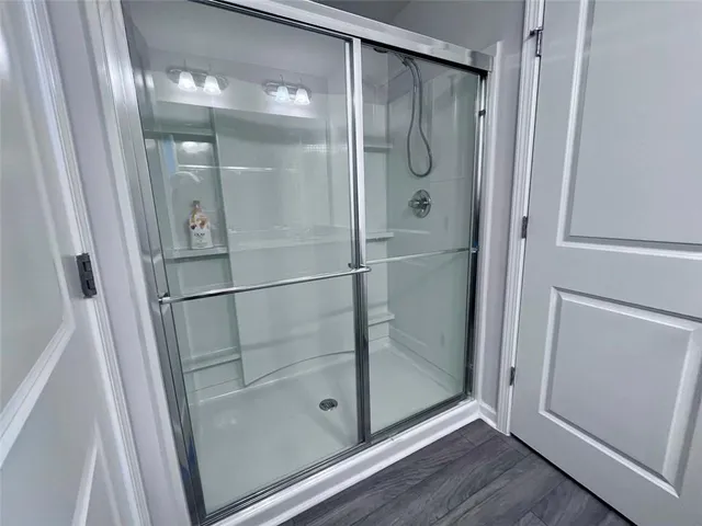 a bathroom with a glass shower door