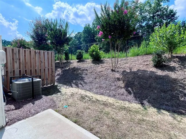 a view of a backyard with a garden and entertaining space