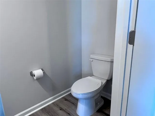 a white toilet sitting next to a sink