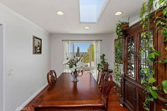 a view of a dining room with furniture and a potted plant