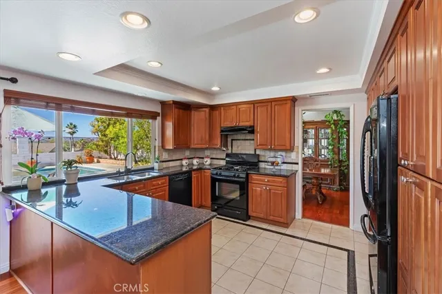 a kitchen with stainless steel appliances granite countertop sink stove and refrigerator