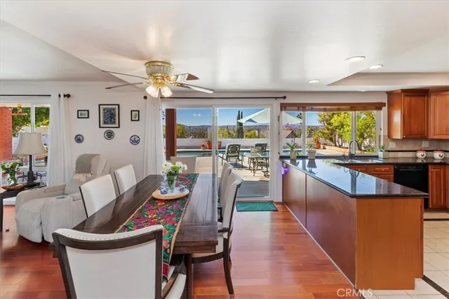a living room with furniture a flat screen tv and a floor to kitchen