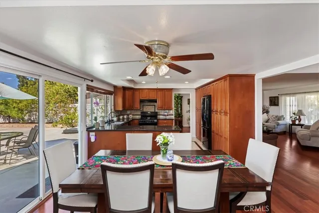 a dining room with furniture a rug and a large window