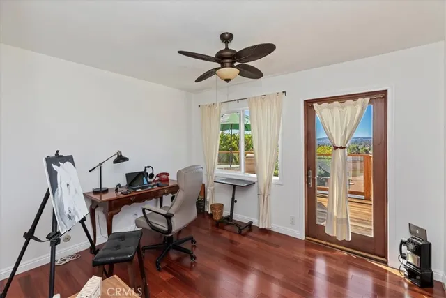 a view of a workspace with furniture and a window