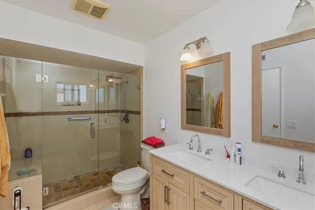 a bathroom with a sink vanity mirror and toilet