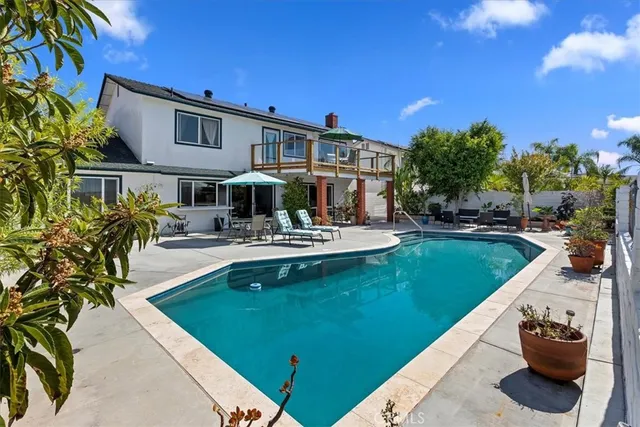 a swimming pool with outdoor seating and yard