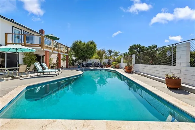 a swimming pool with outdoor seating and yard