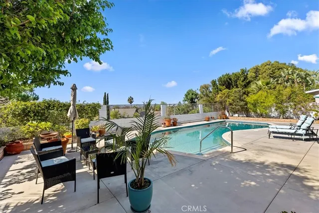 a backyard of a house with table and chairs