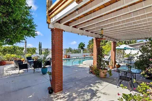 a porch area with table and chairs