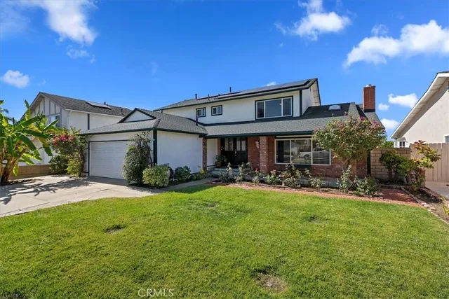 a front view of house with yard and outdoor seating