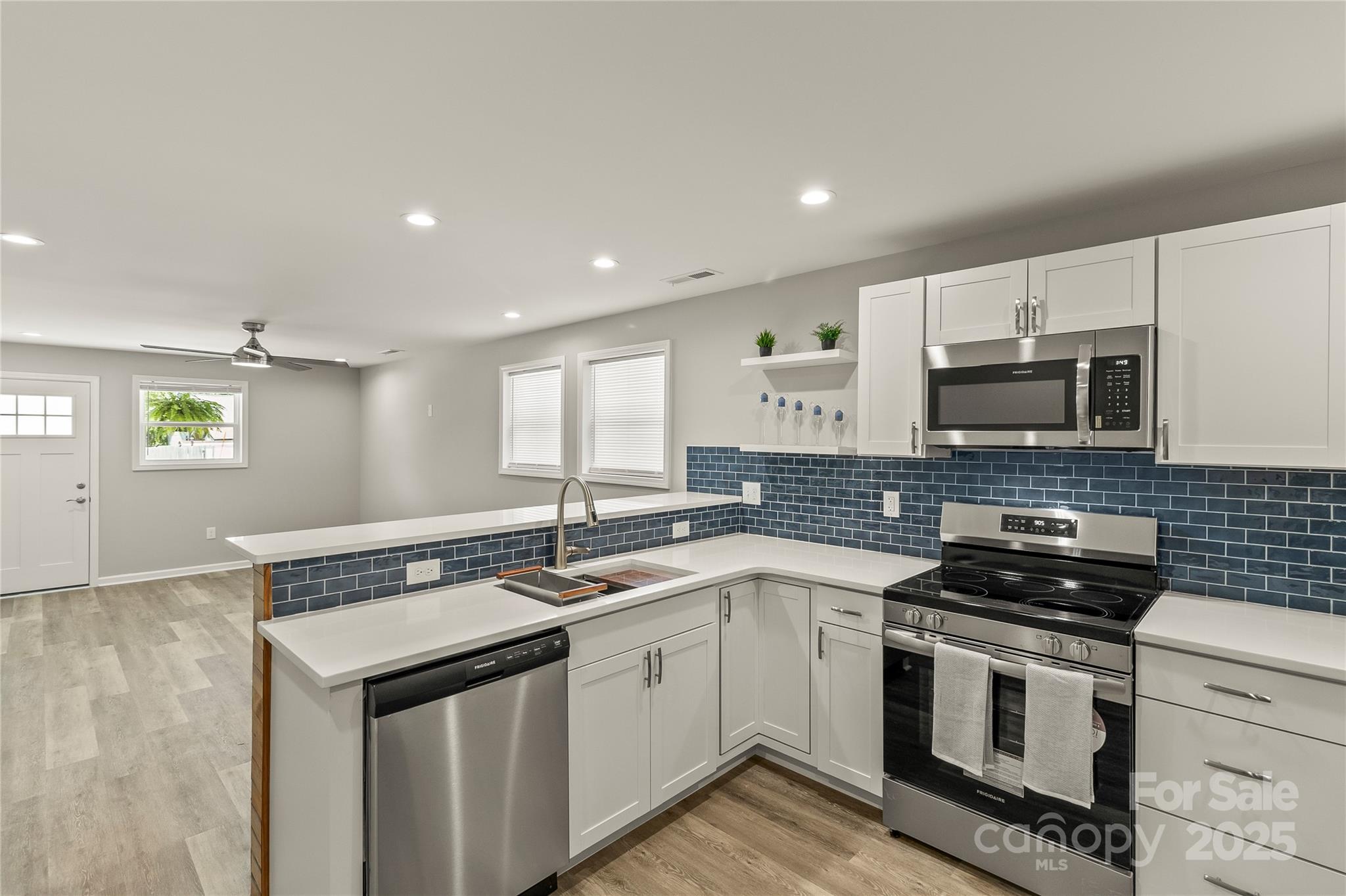 a kitchen with a sink stove and microwave
