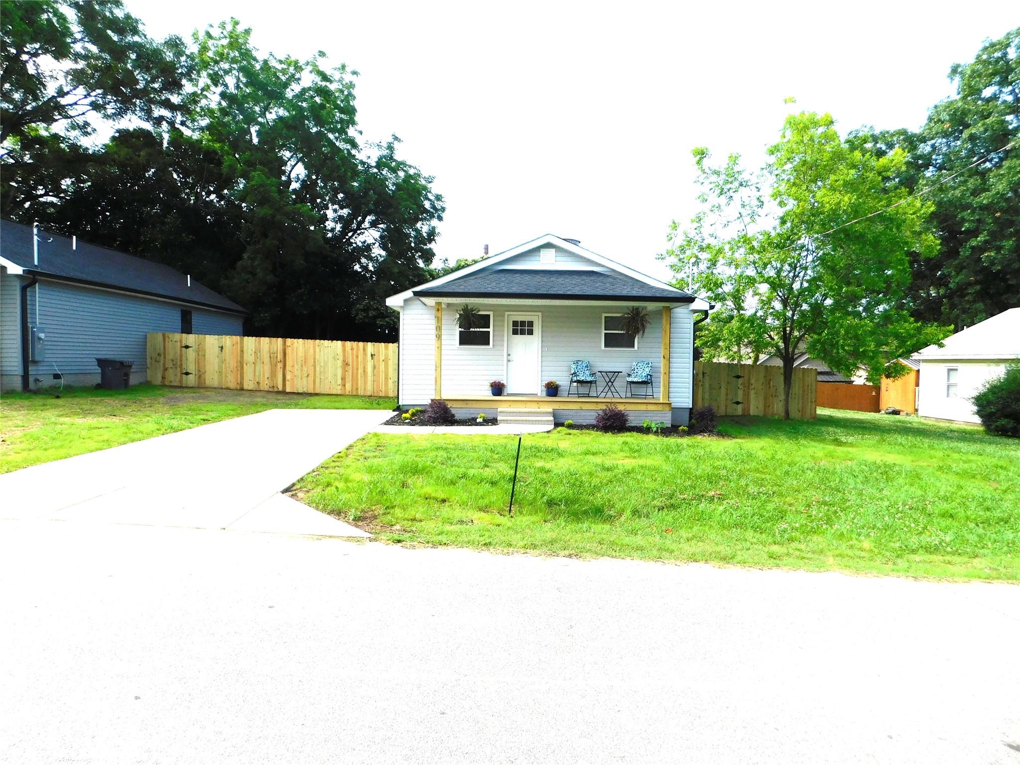 109 West Poplar Street Stanley, NC 28164 - Photo 1 of 45 a front view of a house with a yard and trees