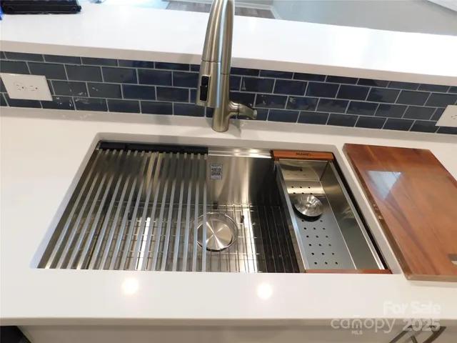 a bedroom with a bed and a lamp on the dresser