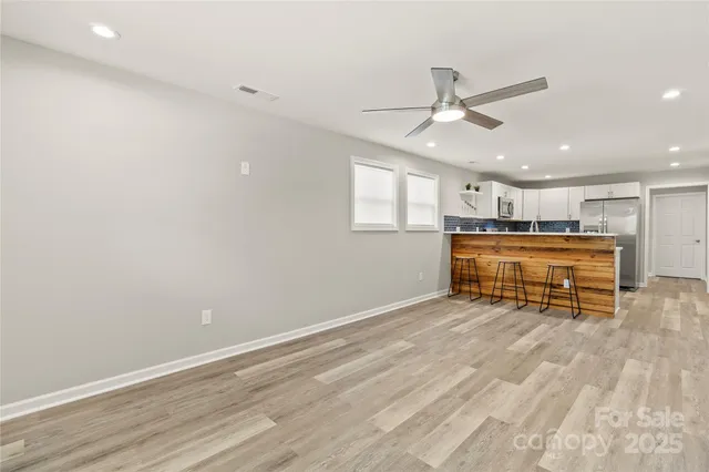 an empty room with a ceiling fan and a window