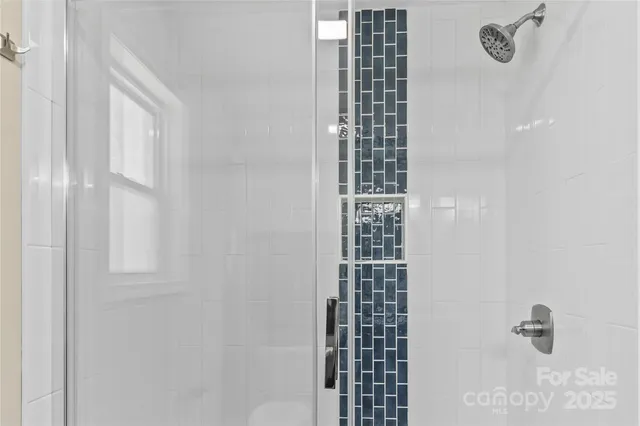 an empty room with a ceiling fan and a window