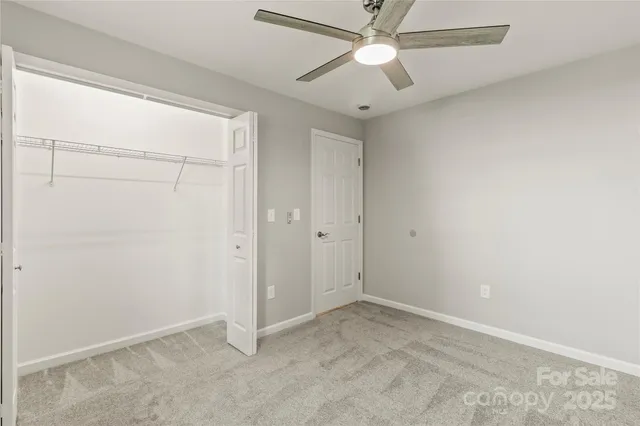 a kitchen with granite countertop a stove a sink and a refrigerator
