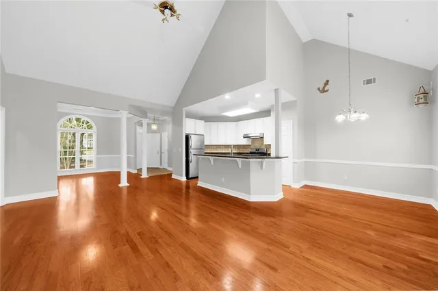 a view of kitchen and hall with wooden floor