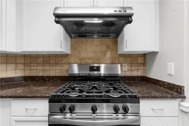 a kitchen with a stove and cabinets