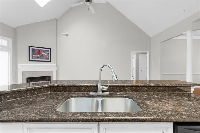 a kitchen with granite countertop a sink and a stove
