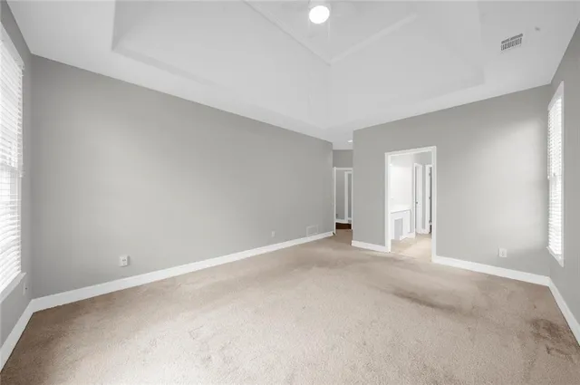 an empty room with windows and closet