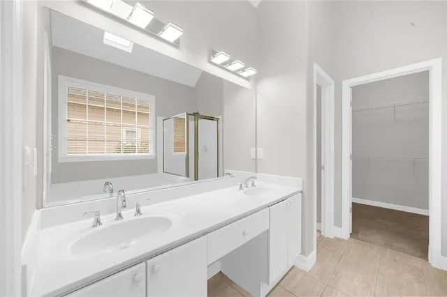 a bathroom with double vanity sinks and a mirror