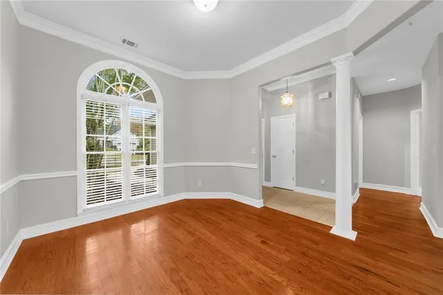 wooden floor in an empty room with a window