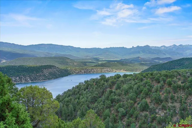 a view of a patio with table and chairs and floor to ceiling window with wooden floor