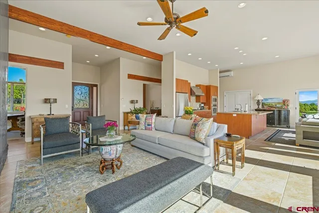 a living room with furniture and kitchen view