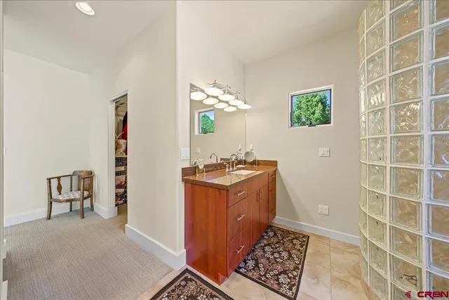 a bathroom with a double vanity sink mirror and bathtub