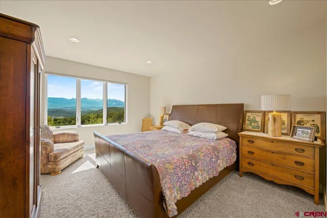 a bathroom with a granite countertop sink a mirror and a shower