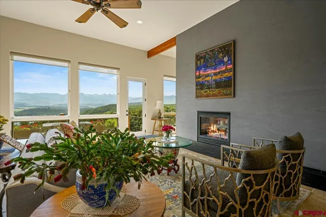 a living room with furniture a potted plant and a fireplace