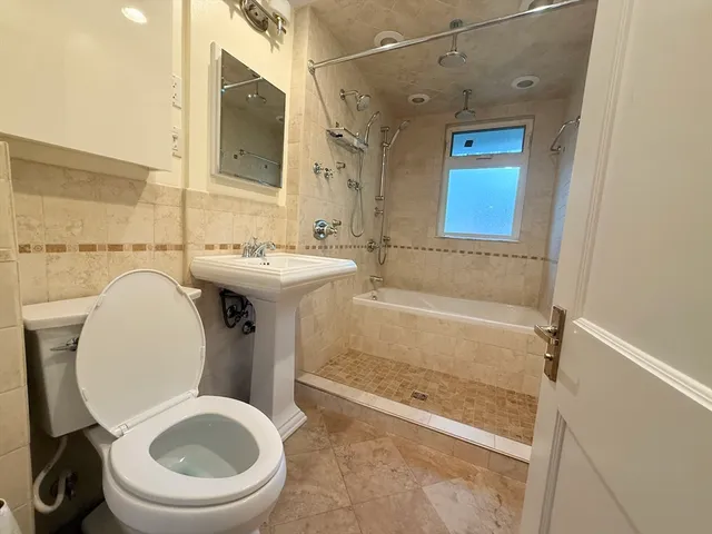 a bathroom with a sink a toilet and bathtub
