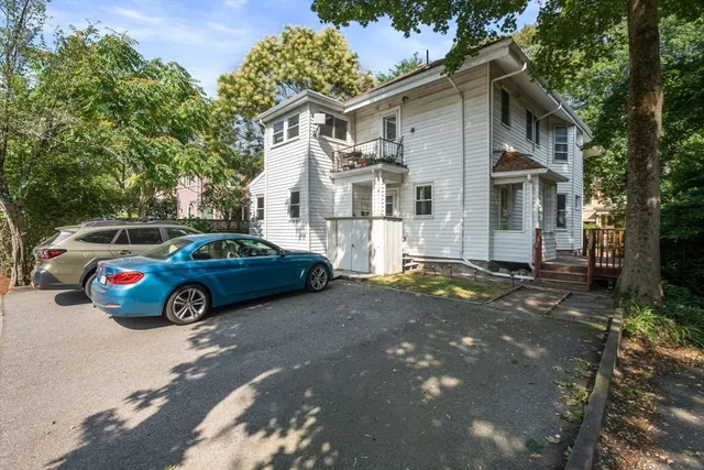 a view of a car parked in front of a house