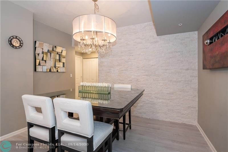 DINING AREA W/ WHITE STONE ACCENT WALL
