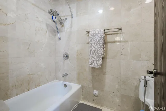 a bathroom with a bathtub and shower