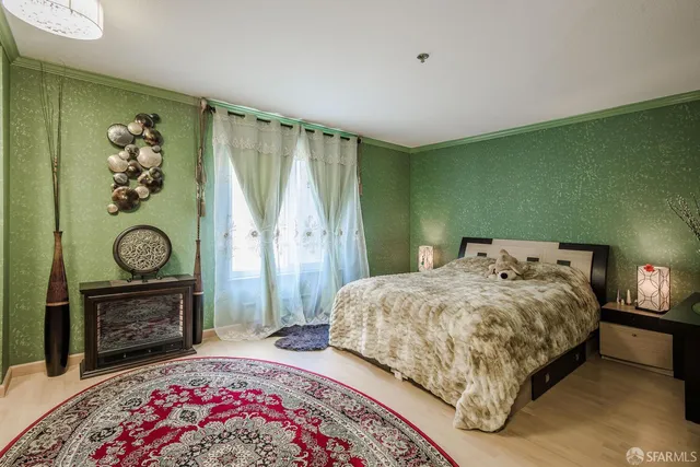 a bedroom with a bed and a fireplace