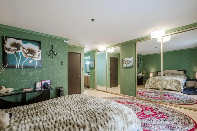 a bedroom with a bed and a chandelier