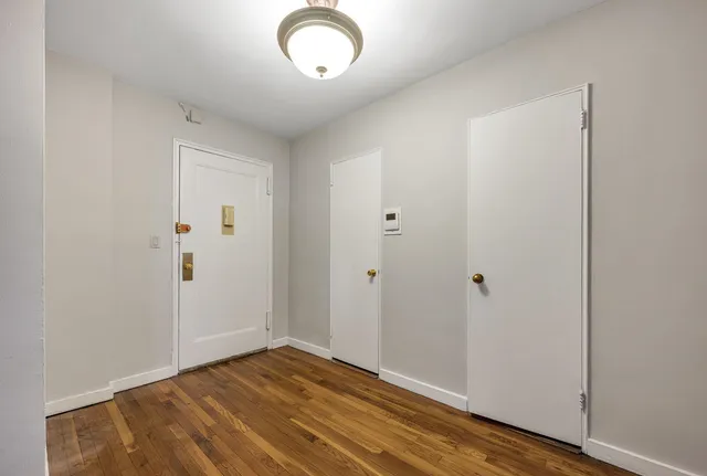 a view of room with wooden floor