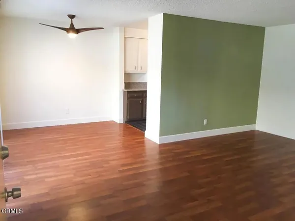 a view of a room with wooden floor