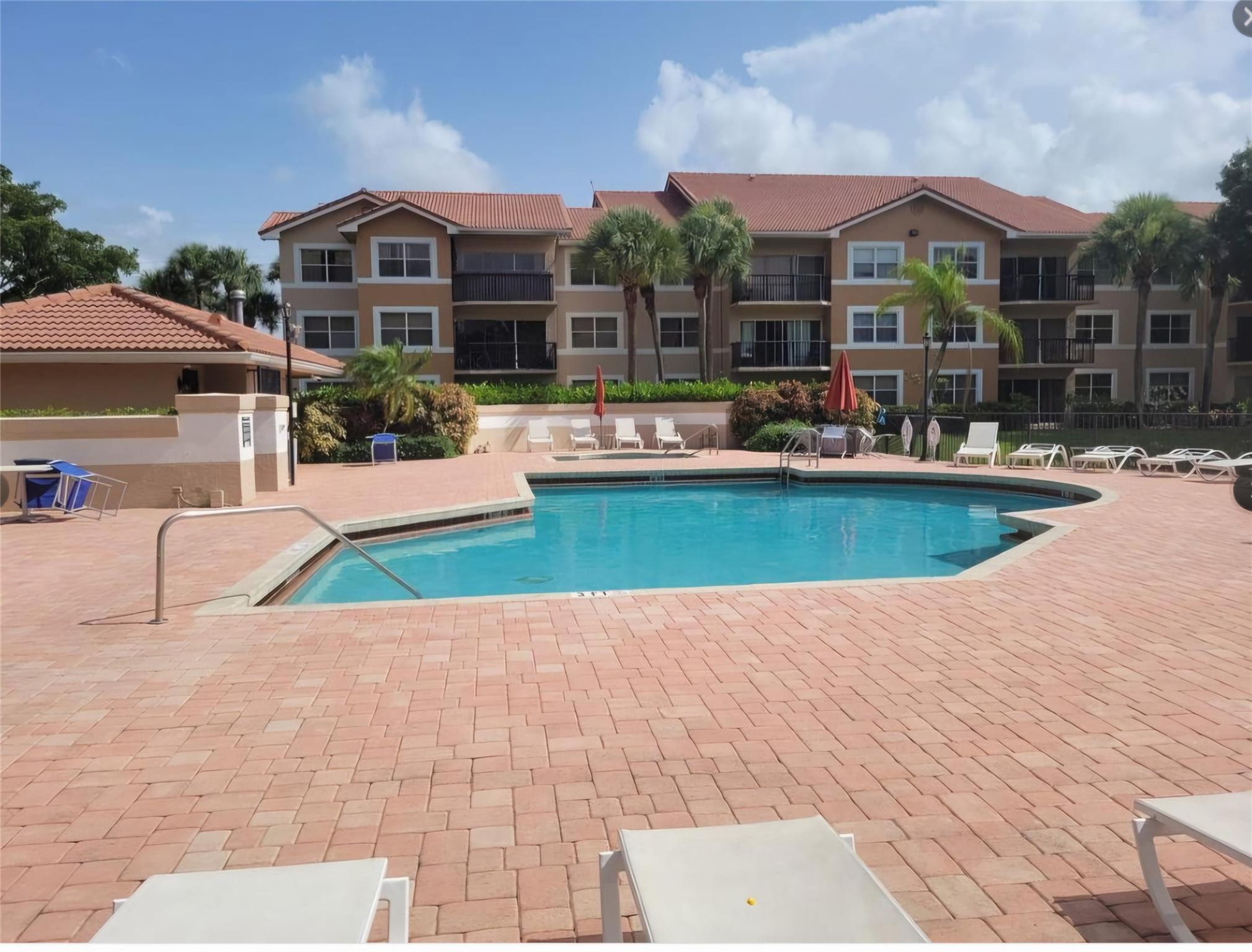 8741 Wiles Road, Unit 305 Coral Springs, FL 33067 - Photo 13 of 20 a view of a house with swimming pool