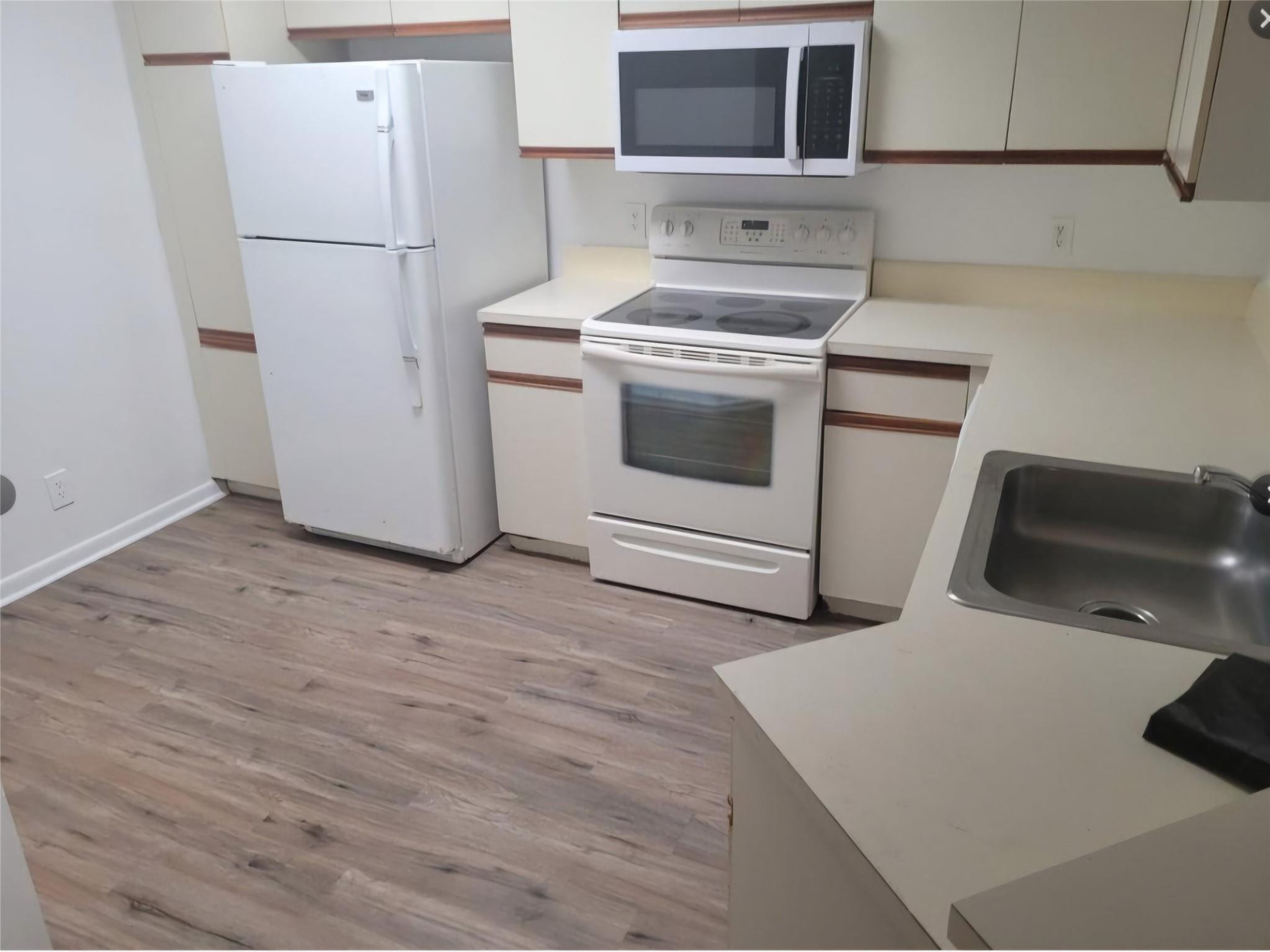 8741 Wiles Road, Unit 305 Coral Springs, FL 33067 - Photo 3 of 20 a kitchen with stainless steel appliances a stove a refrigerator and cabinets
