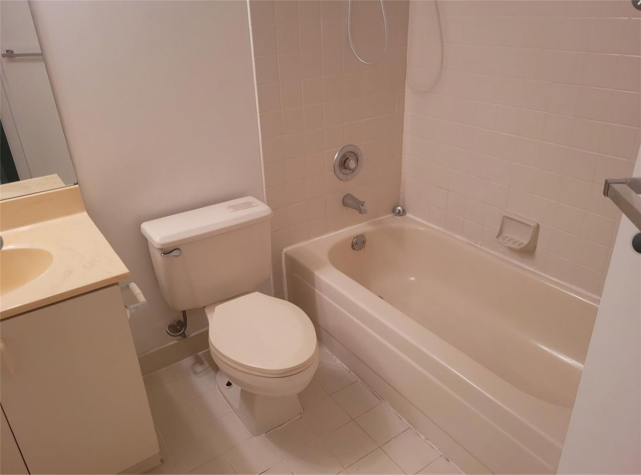 8741 Wiles Road, Unit 305 Coral Springs, FL 33067 - Photo 8 of 20 a white toilet sitting next to a bath tub