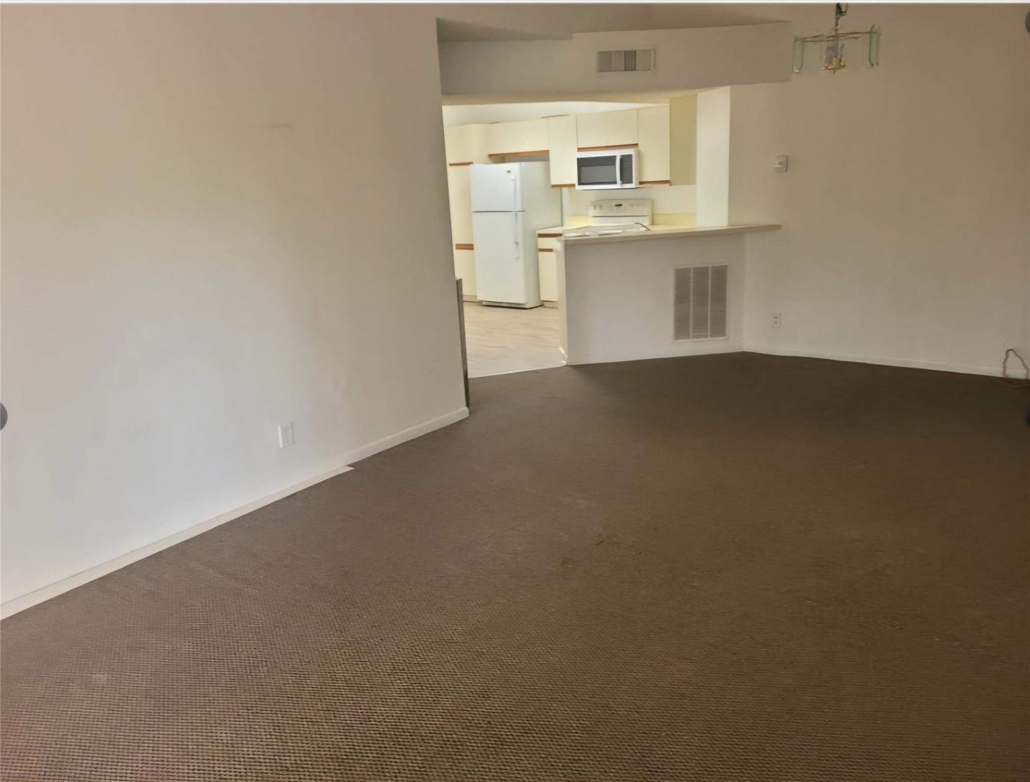 8741 Wiles Road, Unit 305 Coral Springs, FL 33067 - Photo 9 of 20 a view of empty room with wooden floor