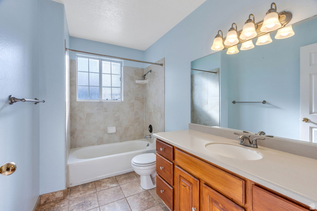 886 West 1700th Street North Mapleton, UT 84664 - Photo 13 of 21 Bathroom featuring a single vanity with wood cabinetry, a white countertop, and a white undermount sink