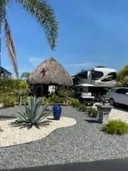 a view of a house with backyard sitting area and swimming pool