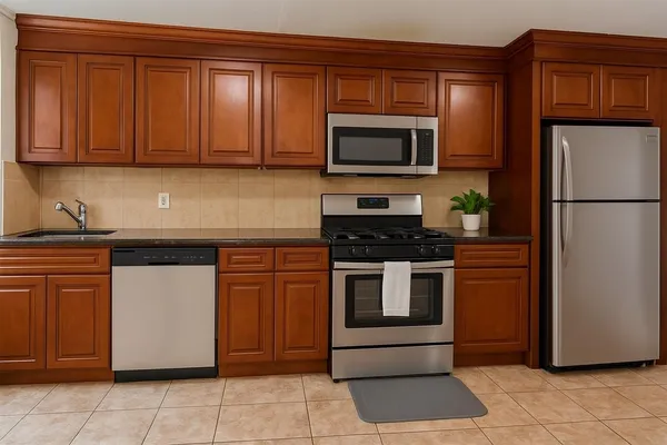 a kitchen with stainless steel appliances granite countertop a refrigerator stove and cabinets